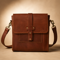 Brown leather crossbody bag on a beige background